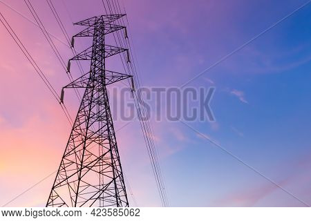 Low Angle Silhouette Of Electric Pole With Purple Blue Sky In The Evening.