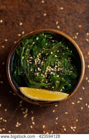 Wakame Salad In Bowl With Peace Of Lemon. Asia Cuisine. Healthy Food