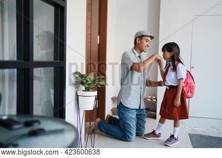 Indonesian Primary School Female Student Shake And Kiss Her Fathers Hand Before Going To School