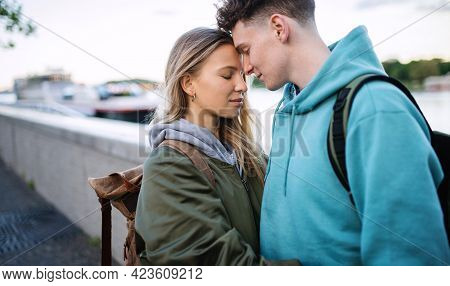 Happy Young Couple Travelers In Love In City On Holiday, Hugging.