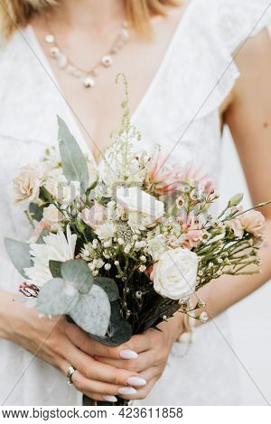 Closeup of a woman holding a flower bouquet