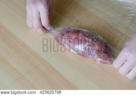 Step By Step Preparation Of Homemade Chopped Ham. Step 10: A Man's Hands Are Twisting A Portion Of M