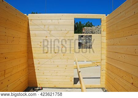 An Empty Door Frame Inside A Partially Constructed Wood (fir) Block House, A Pre-cut Wooden House Wh