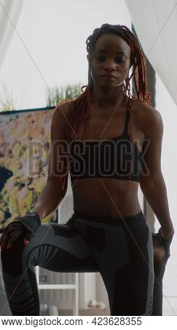 Fitness Woman With Dark Skin Practicing Yoga Workout In Living Room Doing Squat Exercise On Aerobic 