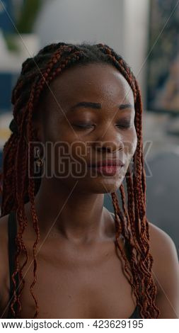 Portrait Of Slim Fit Black Woman Trainer Sitting In Lotus Position Stretching Body Muscles Warming U