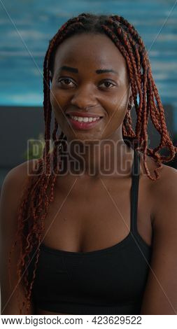 Portrait Of Fit Woman Smiling And Looking Into Camera During Aerobic Morning Workout Sitting On Yoga