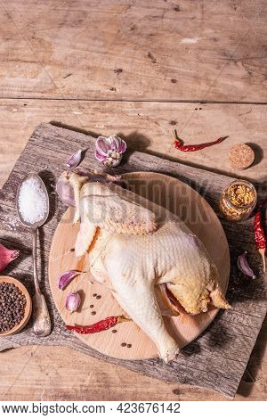 Raw Whole Chicken Carcass For Healthy Food Lifestyle With Red Onion, Garlic Cloves, Spices, And Sea