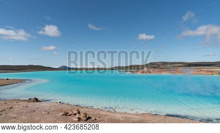 Blue Lake In Hverir Myvatn Geothermal Area With Boiling Mudpools And Steaming Fumaroles In Iceland