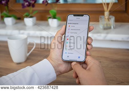 Alanya, Turkey - April 7, 2021: Man Hand With Apple Iphone 12 Pro Max Gold With App Activity Health 