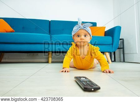 Little Baby Girl Lay On The Floor With Tv Control