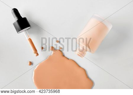 Mockup Glass Bottle Of Correction Cosmetic Product With Pipette. Spilled Liquid Foundation. Beauty B