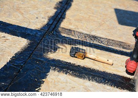 Roofing Construction And Underlayment: Applying A Hot Rubberized Asphalt, Bitumen To Seal The Roof S