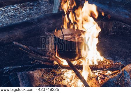 Camping Pot On Fire. Outdoor Steaming Food. Wildlife Lifestyle Cooking Delicious Meal, Copyspace Sto
