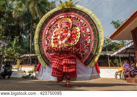 Payyanur, India - December 5, 2019: Theyyam artist perform during temple festival in Payyanur, Kerala, India. Theyyam is a popular ritual form of worship in Kerala, India