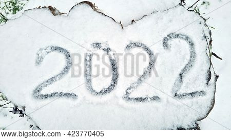 Numbers 2022 Are Written In The Snow On A Wooden Stump In A Winter Park. Ideal For New Year And Chri