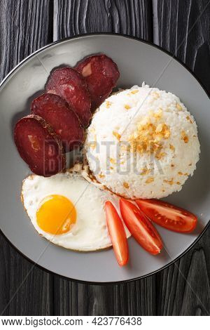 Garlic Rice Served With Fried Egg And Jerky Close-up In A Plate On The Table. Vertical Top View From