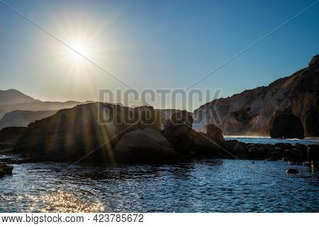 Fyriplaka beach and waves of Aegean sea on sunset, Milos island, Cyclades, Greece