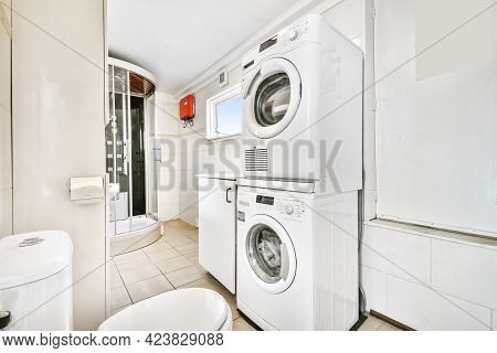 Shower And Bathtub In Light Bathroom With Washing Machine. High Quality Photo