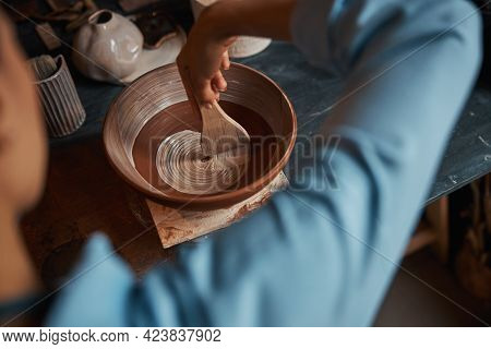 Professional Ceramicist Painting Clay Bowl In Pottery Workshop