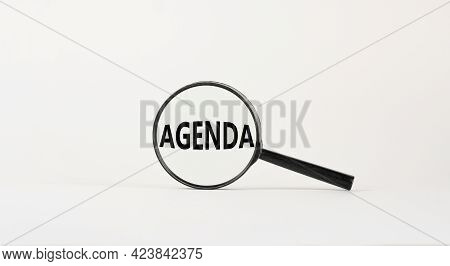 Agenda Symbol. Magnifying Glass With The Concept Word Agenda On Beautiful White Background. Business