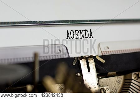 Business And Agenda Symbol. The Concept Word 'agenda' Typed On Retro Typewriter. Beautiful White Bac