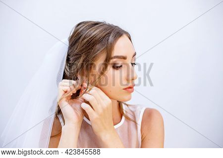 Brunette Girl In A Wedding Dress. Bride In A White Dress. Makeup.