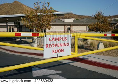 Close Up Of School Campus Reopeing Soon Sign On Gate