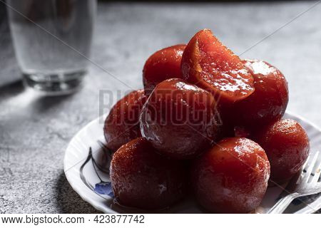 Group Of Tasty Gulab Jamuns And Slice, Indian Sweets Served In A Plate