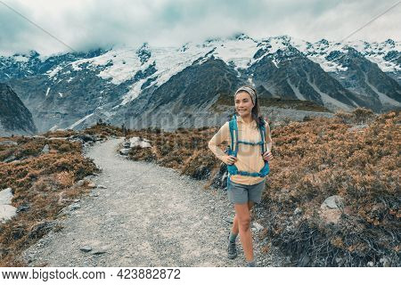 New Zealand tramper backpacking on Mount Cook Aoraki Hooker valley travel. Hiker hiking walking on Hooker Valley Track in summer on travel holiday adventure