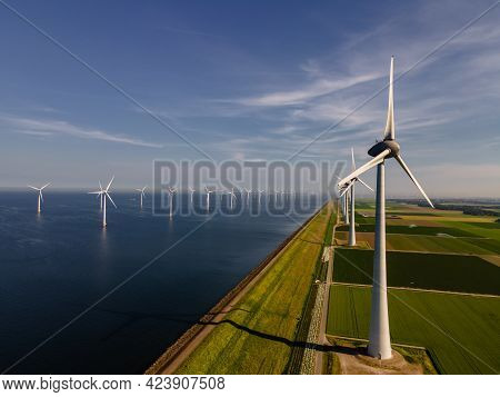 Wind Turbine From An Aerial View, Drone View At Windpark A Windmill Farm In The Lake Ijsselmeer The 