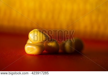 Corn Grains Close Up Against The Cob Of Corn.