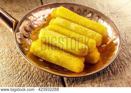 Fried Polenta In A Slotted Spoon, Typical Brazilian Food, Cornmeal And Cornmeal Snacks