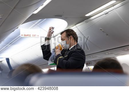 Yekaterinburg. Russia. 01.01.2021. Aeroflot Steward In Uniform Wearing A Medical Mask Instructs Pass
