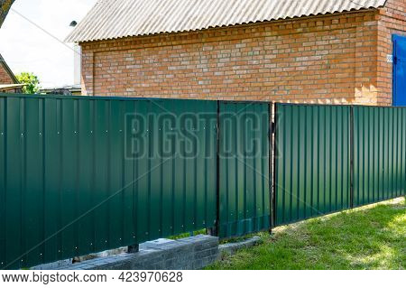 Texture Of Profiled Metal. Metal Fence. Green Metallic Corrugated Fence