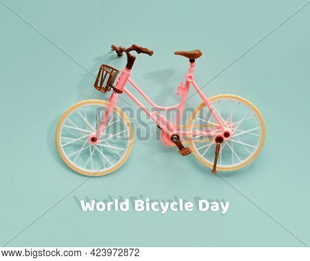 World Bicycle Day On June 3. Toy Model Town Bike With Shadow On Mint Blue Background. Cycling Day. F
