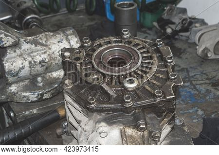 The Old Transfer Case Removed From The Car Is On The Desktop In The Auto Repair Shop