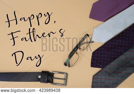Happy Father\\\'s Day Concept With Neck Ties, Reading Glass, Belt And Text. Selective Focus Points