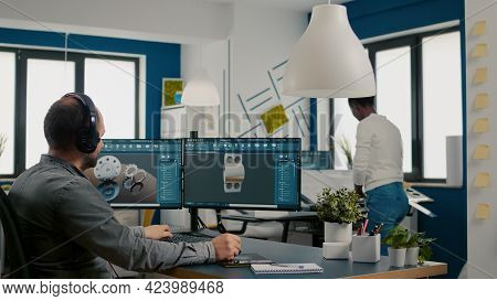Mecanic Technician Working On Cad Software Using Computer With Two Monitors Innovating An Efficient 
