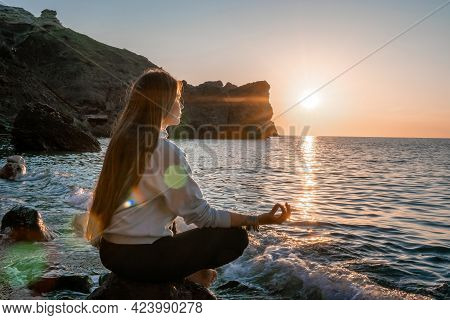 Young Woman With Long Hair In Sportswear And Boho Style Braclets Practicing Outdoors On Yoga Mat By 