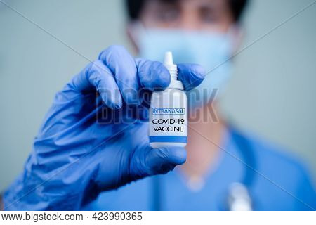 Close Up Hands Of Doctor Or Nurse Holding Intranasal Vaccine Spary Bottle For Coronavirus Or Covid-1