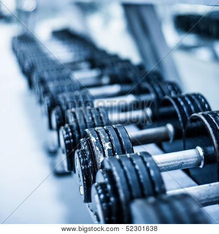 Rows of dumbbells in the gym