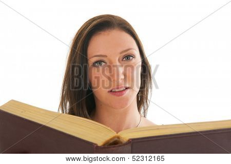 Attractive young girl reading thick old book