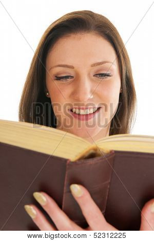 Attractive young girl reading thick old book