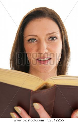 Attractive young girl reading thick old book