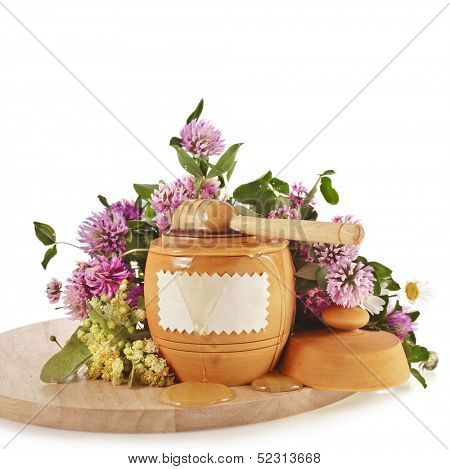 sweet honey in  barrel pot and wooden drizzler in wood board, isolated on white background 