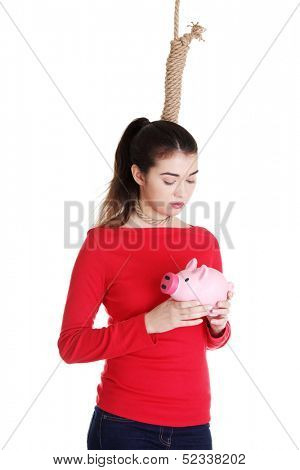 Economic crisis concept. Young woman holding piggy bank going to commit suicide. 