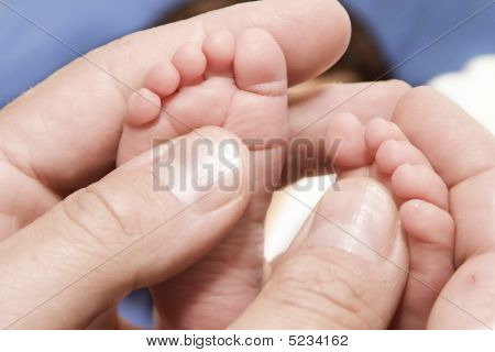 Adult´s Hand And Baby´s Foot