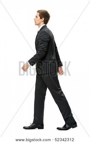 Full-length profile of walking businessman, isolated on white. Concept of leadership and success