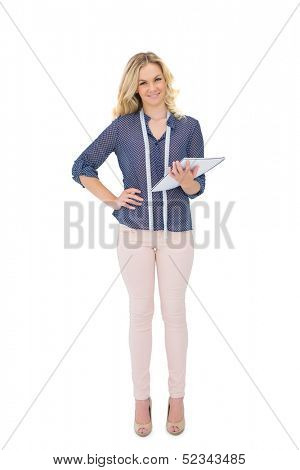 Smiling pretty fashion designer holding sketchpad on white background
