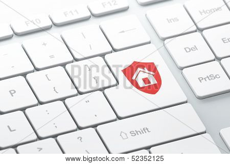 Security concept: Shield on computer keyboard background